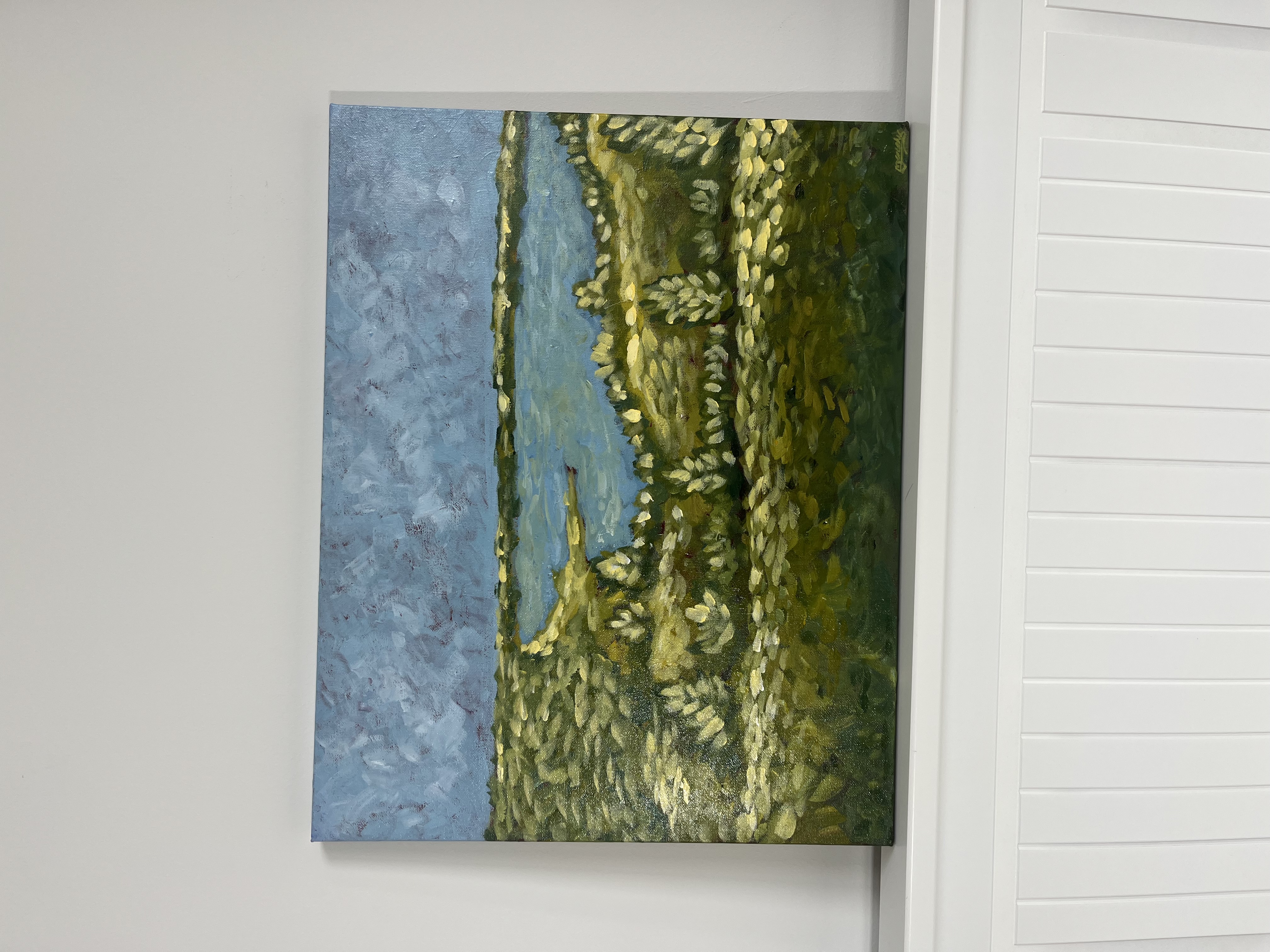 Green fields running down to a blue lake — original landscape painting by Mercedes Michel