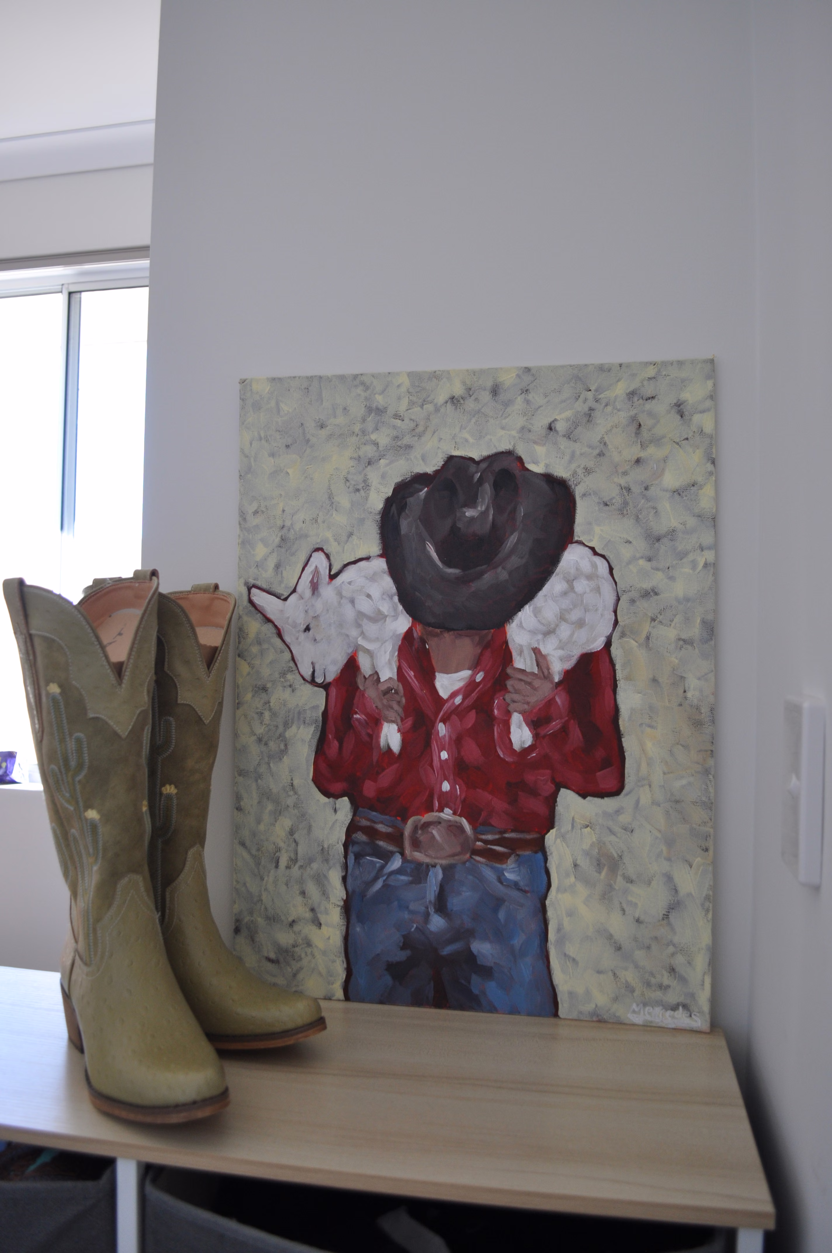 Cowboy carrying a lamb by Mercedes Michel — alternate view 3